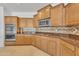 Well-equipped kitchen with stainless steel appliances, wood cabinetry, and decorative backsplash at 14612 W Edgemont Ave, Goodyear, AZ 85395