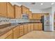 Well-lit kitchen with stainless steel appliances, wood cabinets, and a gas cooktop at 14612 W Edgemont Ave, Goodyear, AZ 85395