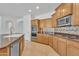 Bright and modern kitchen featuring stainless steel appliances and an island sink at 14612 W Edgemont Ave, Goodyear, AZ 85395