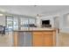 Open kitchen featuring a center island with a sink and views into the living room at 14612 W Edgemont Ave, Goodyear, AZ 85395