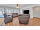 Comfortable living room features ample seating, a ceiling fan, and a large windows at 14612 W Edgemont Ave, Goodyear, AZ 85395