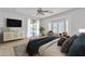 Bright main bedroom features neutral decor, a ceiling fan, and a sliding door to the backyard at 14612 W Edgemont Ave, Goodyear, AZ 85395