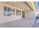 Covered patio offers shade with easy access to the home's interior, featuring sleek windows and sliding glass doors at 14612 W Edgemont Ave, Goodyear, AZ 85395