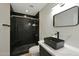 Modern bathroom features a sleek black sink, black shower, and contemporary lighting at 1509 W Kiowa Ave, Mesa, AZ 85202