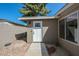 A white front door with pane windows allows natural light to filter through the main room at 1509 W Kiowa Ave, Mesa, AZ 85202