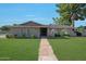 Charming single-story home with well-maintained landscaping and a stone walkway leading to the front door at 1509 W Kiowa Ave, Mesa, AZ 85202