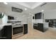 Open kitchen featuring stainless steel appliances, black cabinets, and eat-in breakfast bar at 1509 W Kiowa Ave, Mesa, AZ 85202