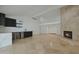 Stylish living room featuring a modern wet bar, a cozy fireplace, and travertine floors throughout at 1509 W Kiowa Ave, Mesa, AZ 85202