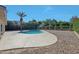 Relaxing backyard featuring a refreshing pool, a gravel area, and plenty of mature landscaping for privacy at 1509 W Kiowa Ave, Mesa, AZ 85202