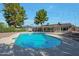 Backyard view of sparkling pool surrounded by gravel and mature trees, creating a private oasis at 1509 W Kiowa Ave, Mesa, AZ 85202