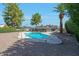 Backyard pool area with desert landscaping, mature trees, and a well-kept swimming pool at 1509 W Kiowa Ave, Mesa, AZ 85202