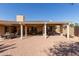 Backyard with multiple seating areas under pergola, ideal for relaxing and enjoying the outdoors at 15479 W Whitton Ave, Goodyear, AZ 85395