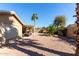 Charming backyard with covered patio and mature desert landscaping for serene outdoor living at 15479 W Whitton Ave, Goodyear, AZ 85395