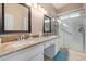 Bright bathroom with a glass-enclosed shower, double sinks, and granite countertops at 15479 W Whitton Ave, Goodyear, AZ 85395