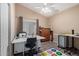 Functional bedroom featuring a work space, ceiling fan, and neutral decor at 15479 W Whitton Ave, Goodyear, AZ 85395