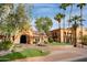 Stunning exterior of the community clubhouse with lush landscaping and decorative entrance at 15479 W Whitton Ave, Goodyear, AZ 85395