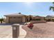 Charming single-story home with a well-manicured desert landscape and a two-car garage at 15479 W Whitton Ave, Goodyear, AZ 85395