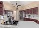 Modern kitchen featuring granite countertops, stainless appliances, and decorative backsplash at 15479 W Whitton Ave, Goodyear, AZ 85395