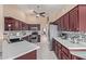 Stylish kitchen with stainless steel appliances, granite countertops, and ample cabinet space at 15479 W Whitton Ave, Goodyear, AZ 85395