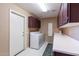 Functional laundry room with a washer, dryer, sink, and ample storage at 15479 W Whitton Ave, Goodyear, AZ 85395