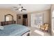 Serene bedroom with plush carpet, ceiling fan, and sliding door access to outdoor space at 15479 W Whitton Ave, Goodyear, AZ 85395