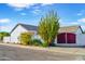 Home's side yard featuring privacy wall, desert landscaping, and gate at 16029 N 36Th Dr, Phoenix, AZ 85053