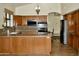 Spacious kitchen featuring granite countertops, stainless steel appliances, and ample cabinet space at 16029 N 36Th Dr, Phoenix, AZ 85053