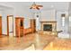 Cozy living room with a stone fireplace, vaulted ceiling, and stylish ceiling fan offers warmth and charm at 16029 N 36Th Dr, Phoenix, AZ 85053