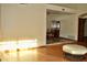 Bright living room showcasing an airy atmosphere, hardwood floors, and seamless flow into the dining area at 16029 N 36Th Dr, Phoenix, AZ 85053