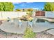 Backyard swimming pool featuring a rock waterfall, beautiful landscaping, and lounge chairs at 16029 N 36Th Dr, Phoenix, AZ 85053