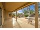 Covered patio with views of the meticulously maintained backyard and outdoor dining furniture at 16051 W Desert Winds Dr, Surprise, AZ 85374