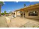 Expansive back patio featuring a pergola, desert landscaping, and furniture for outdoor dining at 16051 W Desert Winds Dr, Surprise, AZ 85374