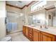 Bathroom with double vanity, walk-in shower, and abundant natural light at 16051 W Desert Winds Dr, Surprise, AZ 85374