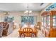 Dining area with wooden table, chairs, china cabinet and sliding glass door to backyard at 16051 W Desert Winds Dr, Surprise, AZ 85374