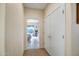 Hallway leading to a bedroom, featuring neutral walls and tile flooring at 16051 W Desert Winds Dr, Surprise, AZ 85374