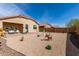 Charming backyard with desert landscaping and covered patio creates a unique outdoor living space at 16593 W Alameda Rd, Surprise, AZ 85387