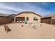 Expansive backyard with desert landscaping, covered patio, and ample space for outdoor activities at 16593 W Alameda Rd, Surprise, AZ 85387