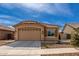 Attractive single-story house featuring a tile roof and well maintained desert landscaping at 16593 W Alameda Rd, Surprise, AZ 85387