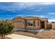 Charming single-story house featuring a tile roof and well maintained desert landscaping at 16593 W Alameda Rd, Surprise, AZ 85387