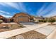 Well-kept single-story house featuring a tile roof and well maintained desert landscaping at 16593 W Alameda Rd, Surprise, AZ 85387