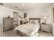 Comfortable bedroom with a large window, carpeted floors, and ensuite bathroom at 16593 W Alameda Rd, Surprise, AZ 85387