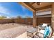 Covered patio features outdoor seating, desert landscaping, and charming decor for relaxing at 16593 W Alameda Rd, Surprise, AZ 85387