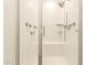 Modern shower with white tile surround, glass door, and built-in bench at 16593 W Alameda Rd, Surprise, AZ 85387