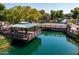 Stunning aerial view of a gazebo overlooking a scenic pond with lush landscaping and a charming bridge at 1677 E Bridgeport Pkwy, Gilbert, AZ 85295