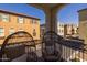 Inviting balcony view with egg chairs overlooking a charming neighborhood at 1677 E Bridgeport Pkwy, Gilbert, AZ 85295