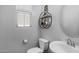 Neat powder room featuring a sleek, modern sink, minimalist decorations, and functional shelving at 1677 E Bridgeport Pkwy, Gilbert, AZ 85295