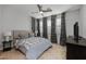 Comfortable bedroom featuring a well-made bed, carpeted floors, a ceiling fan, and decorative window coverings at 1677 E Bridgeport Pkwy, Gilbert, AZ 85295