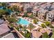 Aerial view of the community pool, palm trees, and well-maintained grounds at 1677 E Bridgeport Pkwy, Gilbert, AZ 85295