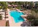 Overhead view of the community pool with many palm trees and a spa at 1677 E Bridgeport Pkwy, Gilbert, AZ 85295