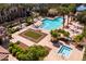 Overhead view of a community pool, spa, and lounge area surrounded by palm trees at 1677 E Bridgeport Pkwy, Gilbert, AZ 85295